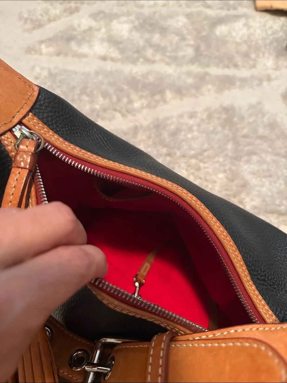 Dooney & Bourke Black and Tan Pebbled Leather Hobo with Tassel